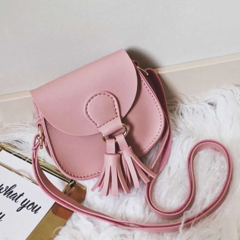 TASSEL crossbody. Salmon colored faux leather with adjustable strap